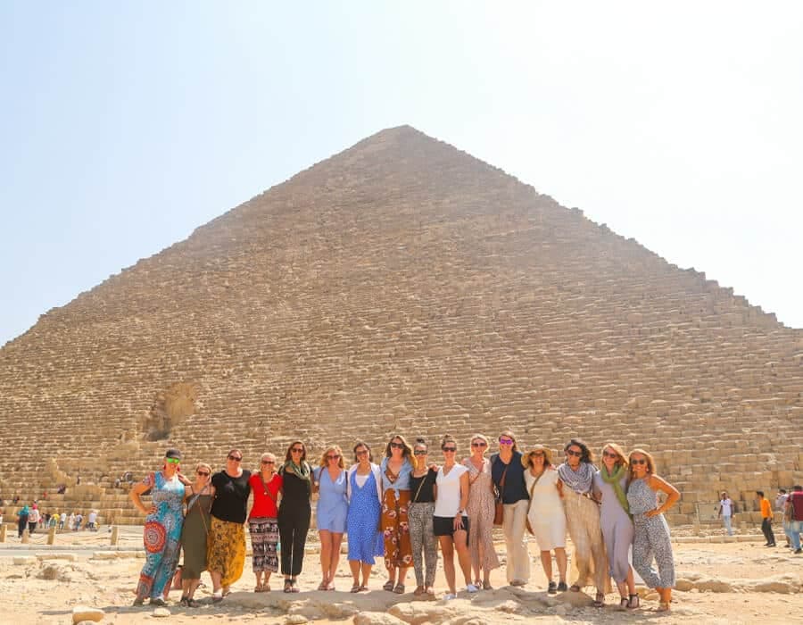 Travelers in front of the Pyramids of Giza on an Egypt tour deal